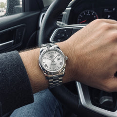 Chancellor Silver / White on the wrist inside a car