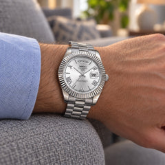 Chancellor Silver / White on the wrist resting on a grey sofa