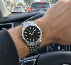 Meridian Silver / Black on the wrist inside a car